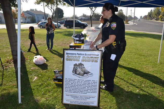 Lemoore PD Commander, Margaret Ochoa helps out at the annual Shoe Drive.